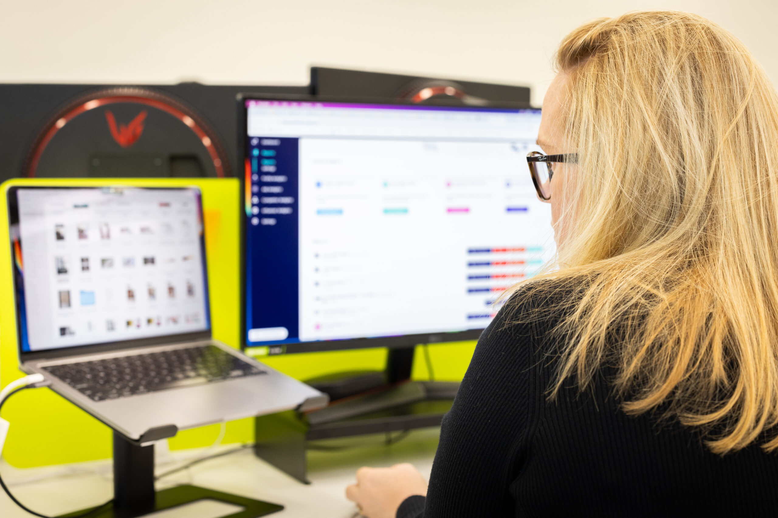 An Ignyt Social media managing using an advanced program on her computer to schedule her client's social media for success